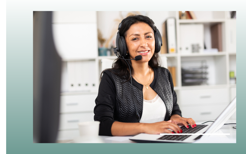 professional office worker smiling in front of computer 